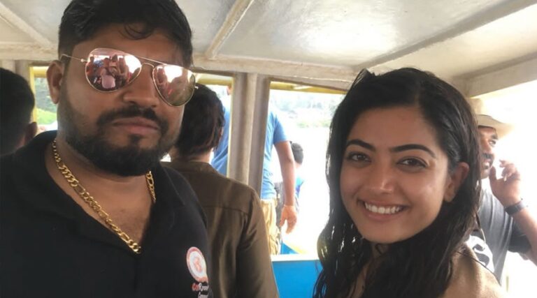 Man with sunglasses and woman smiling for a selfie on the boat